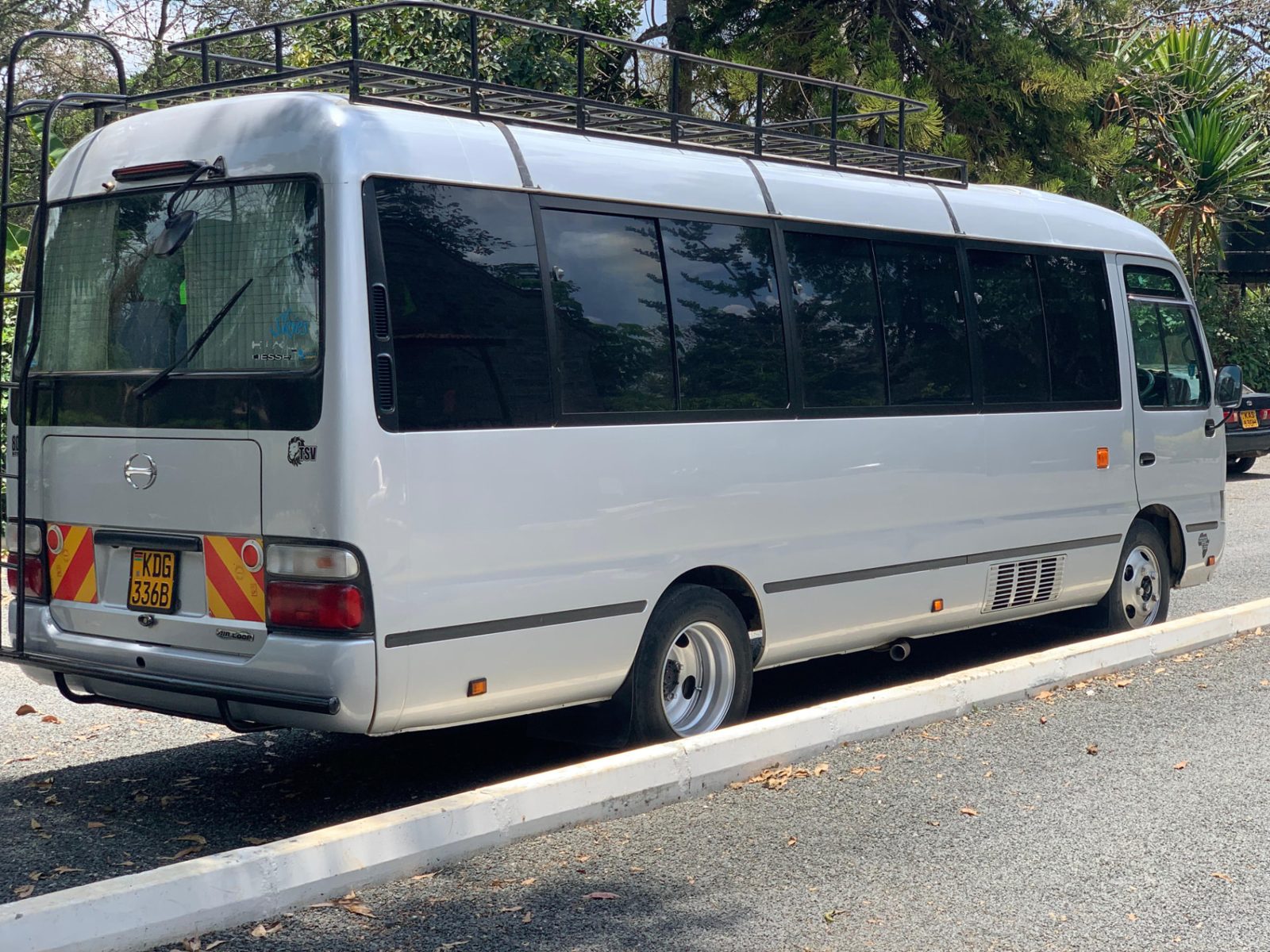 Side profile of our long wheelbase Coaster bus with roof luggage rack