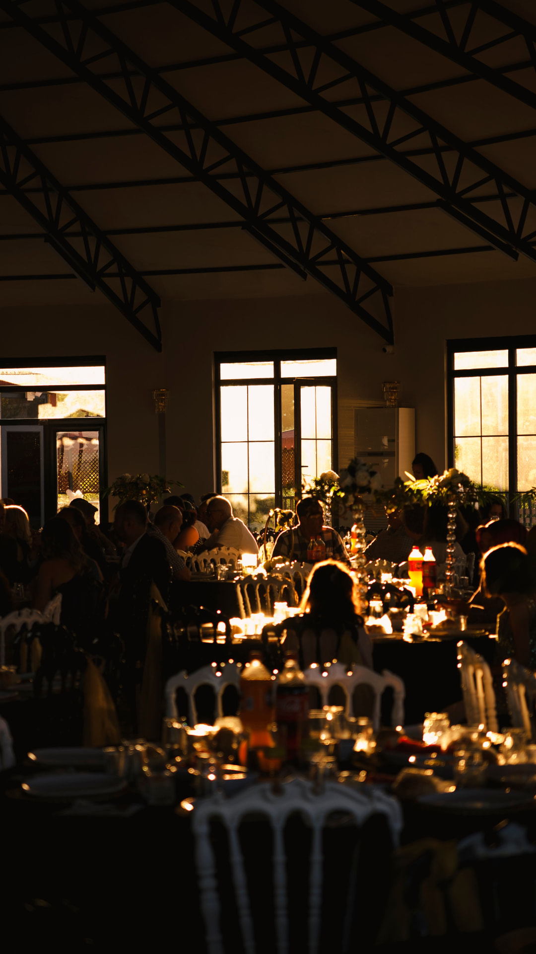 Guests seated at a golden-hour indoor celebration