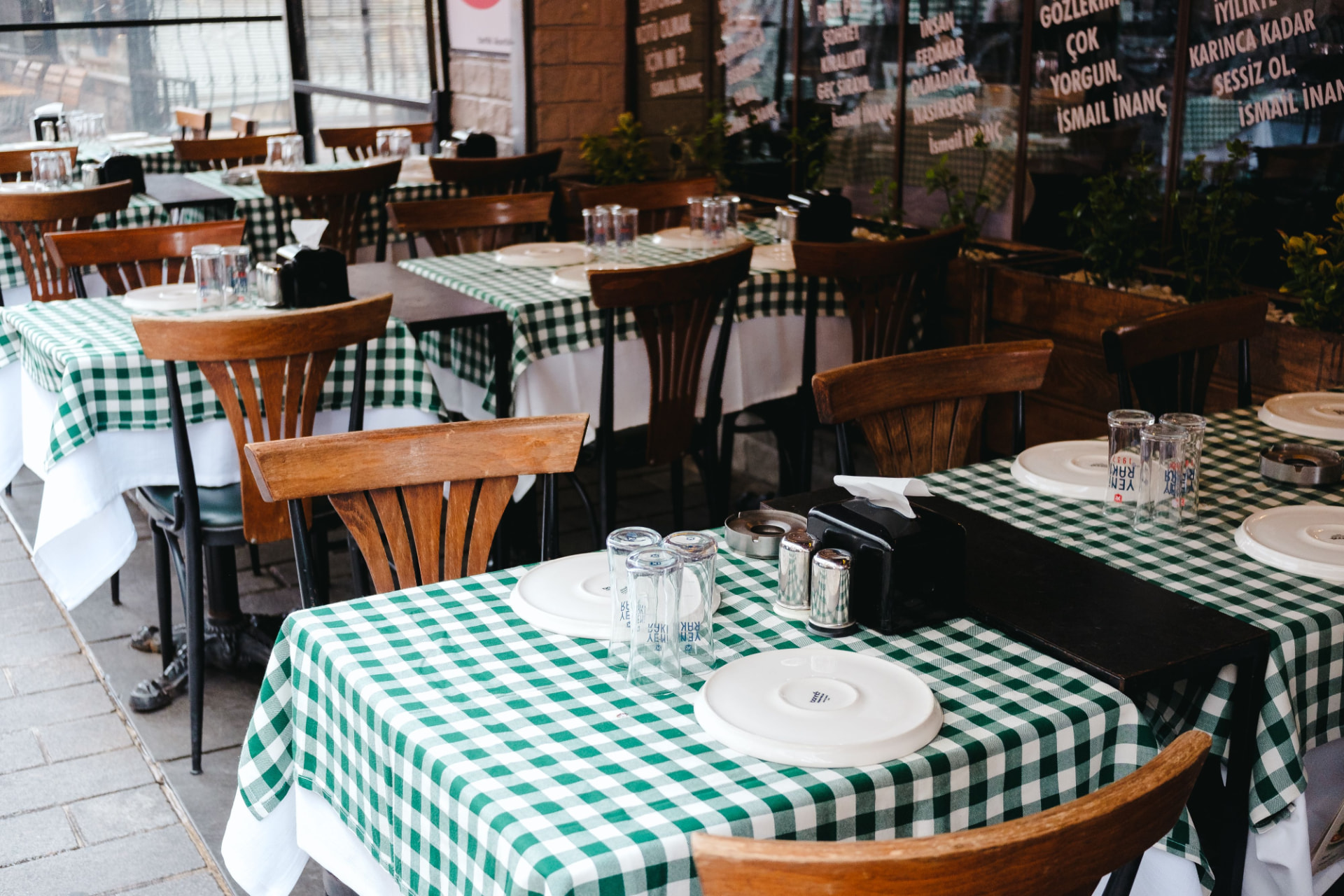 Terrace restaurant set with checked linen for a group lunch