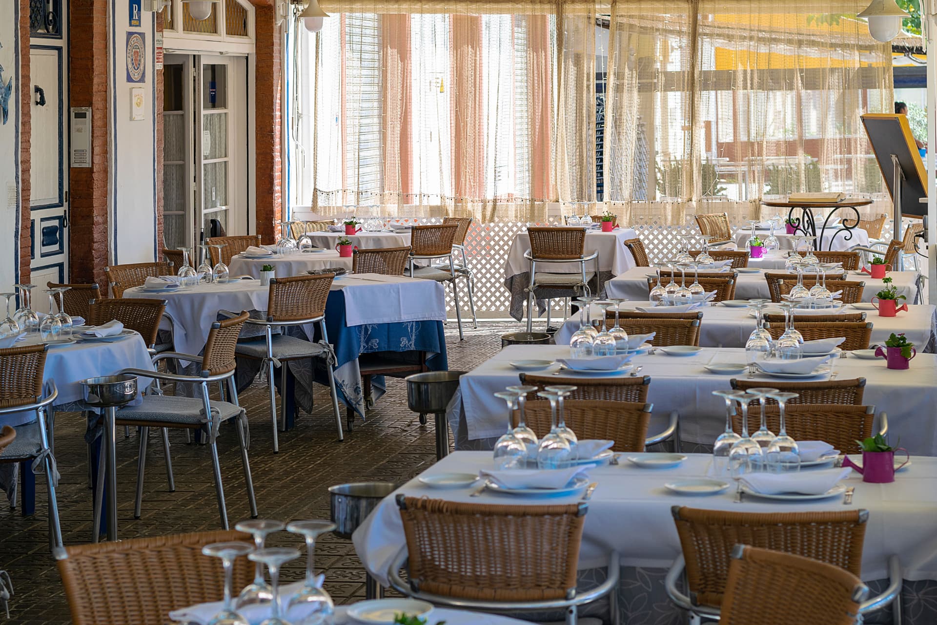 Airy terrace restaurant set for a group lunch