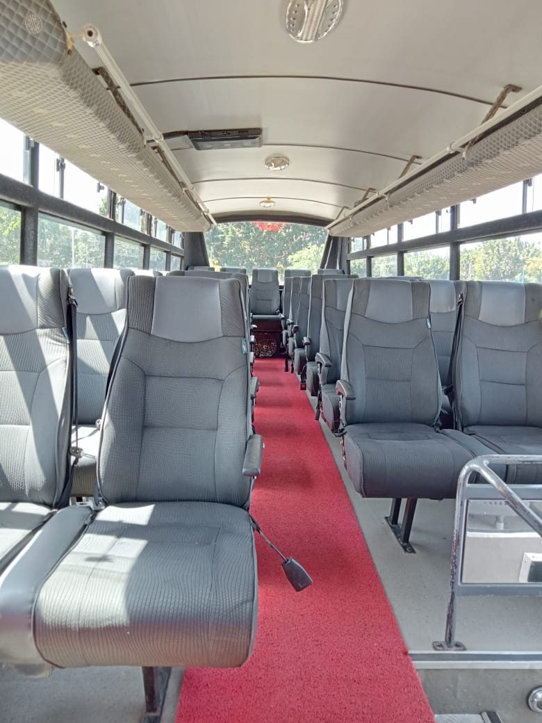 Interior aisle of the Mercedes Benz coach with reclining fabric seats