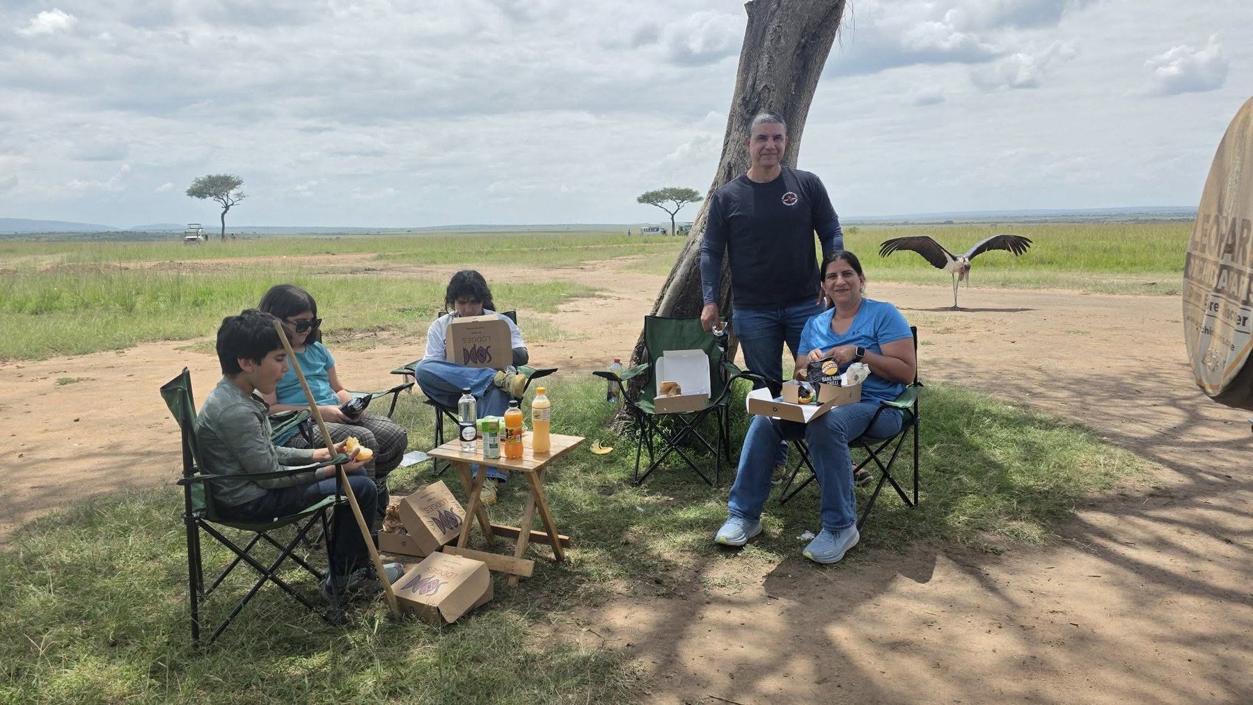 Family enjoying a sundowner on safari