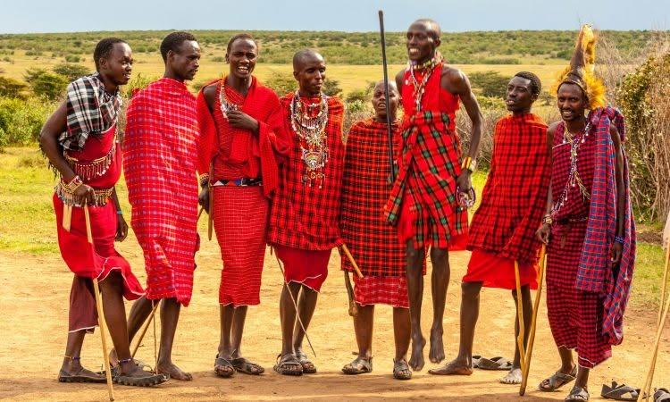Guests visiting a Maasai village with our guide